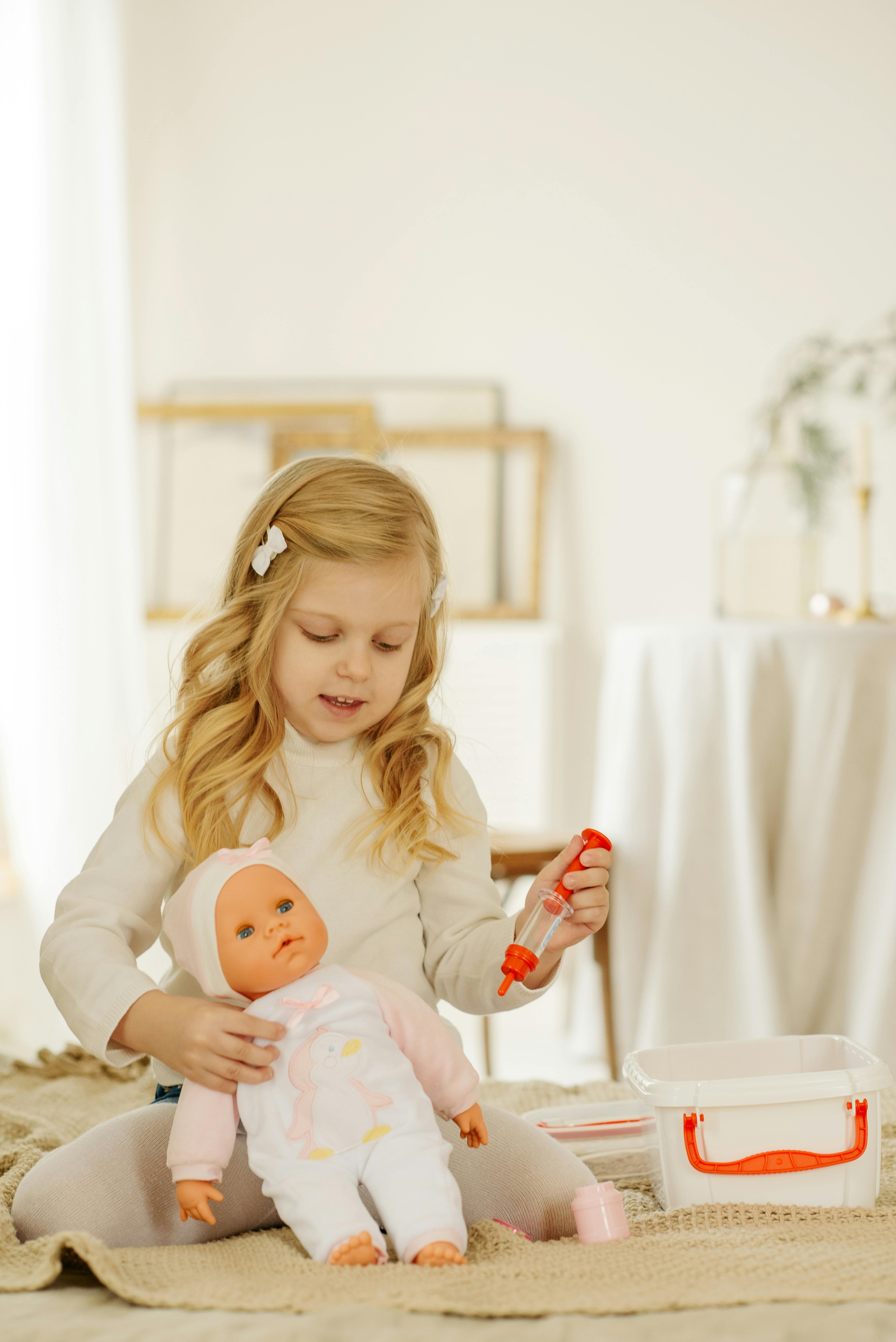 A little girl playing with a doll | Source: Pexels