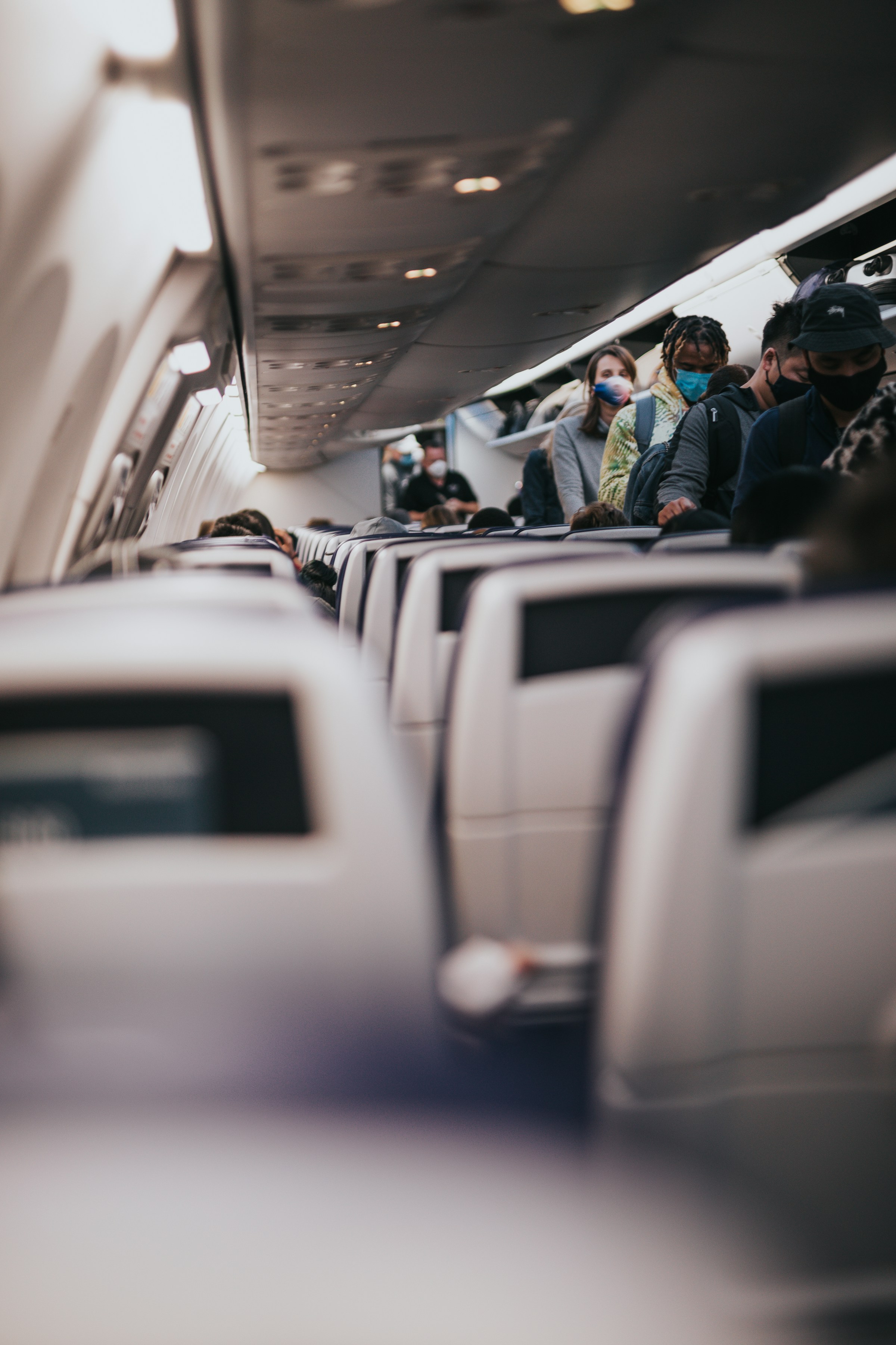 People taking their seats on an airplane | Source: Unsplash