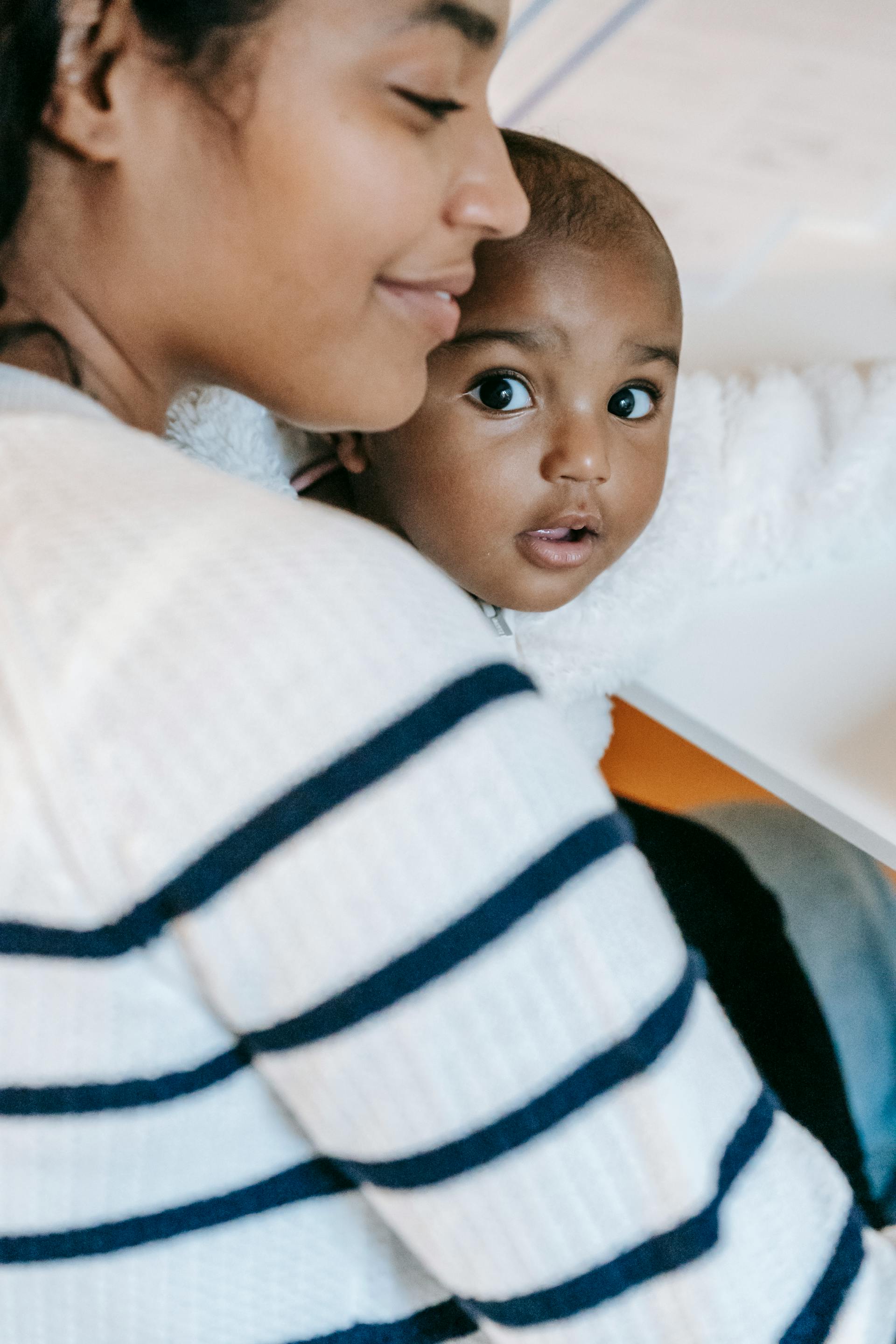 A woman holding her baby | Source: Pexels