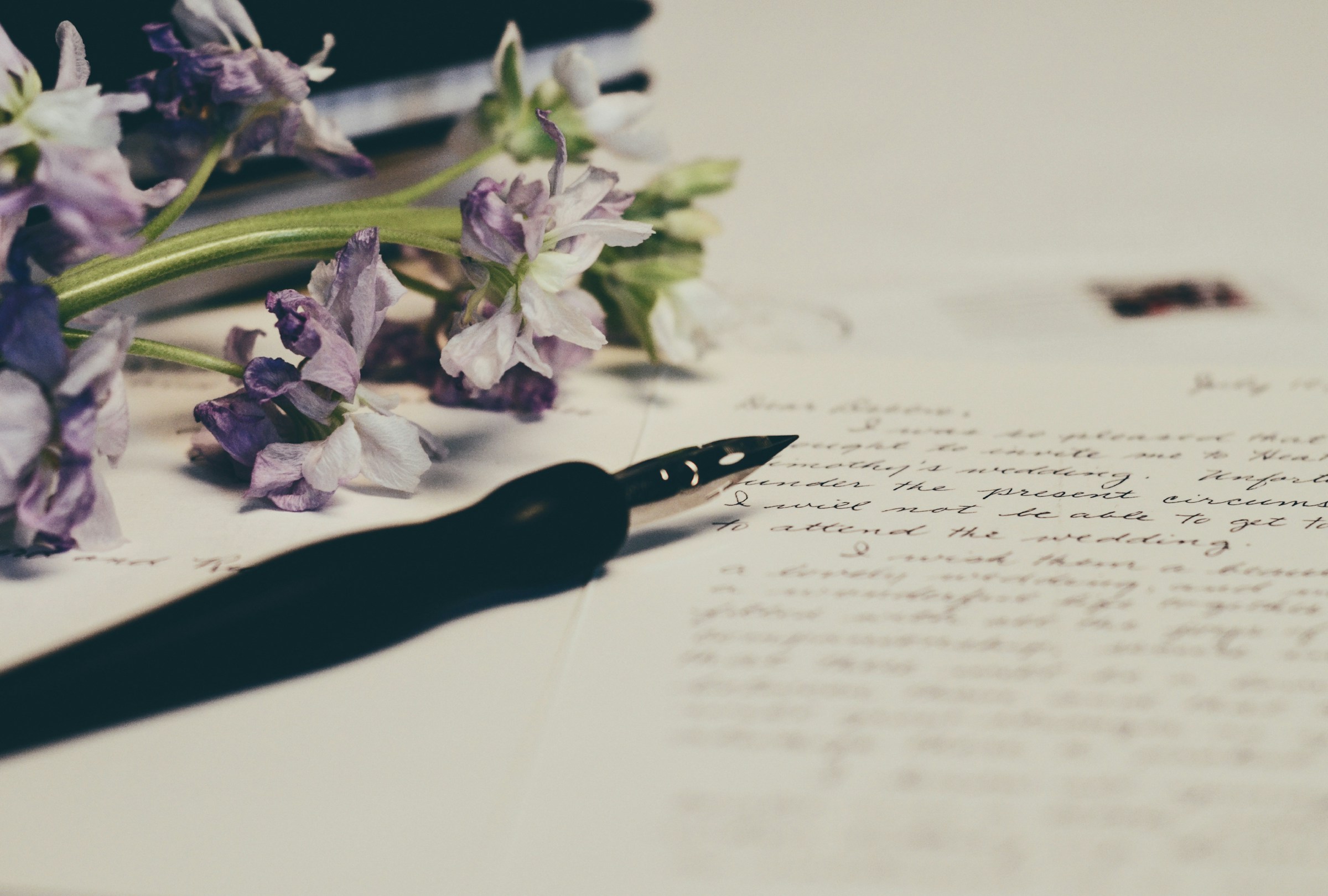 A pen resting on a sheet of paper | Source: Unsplash